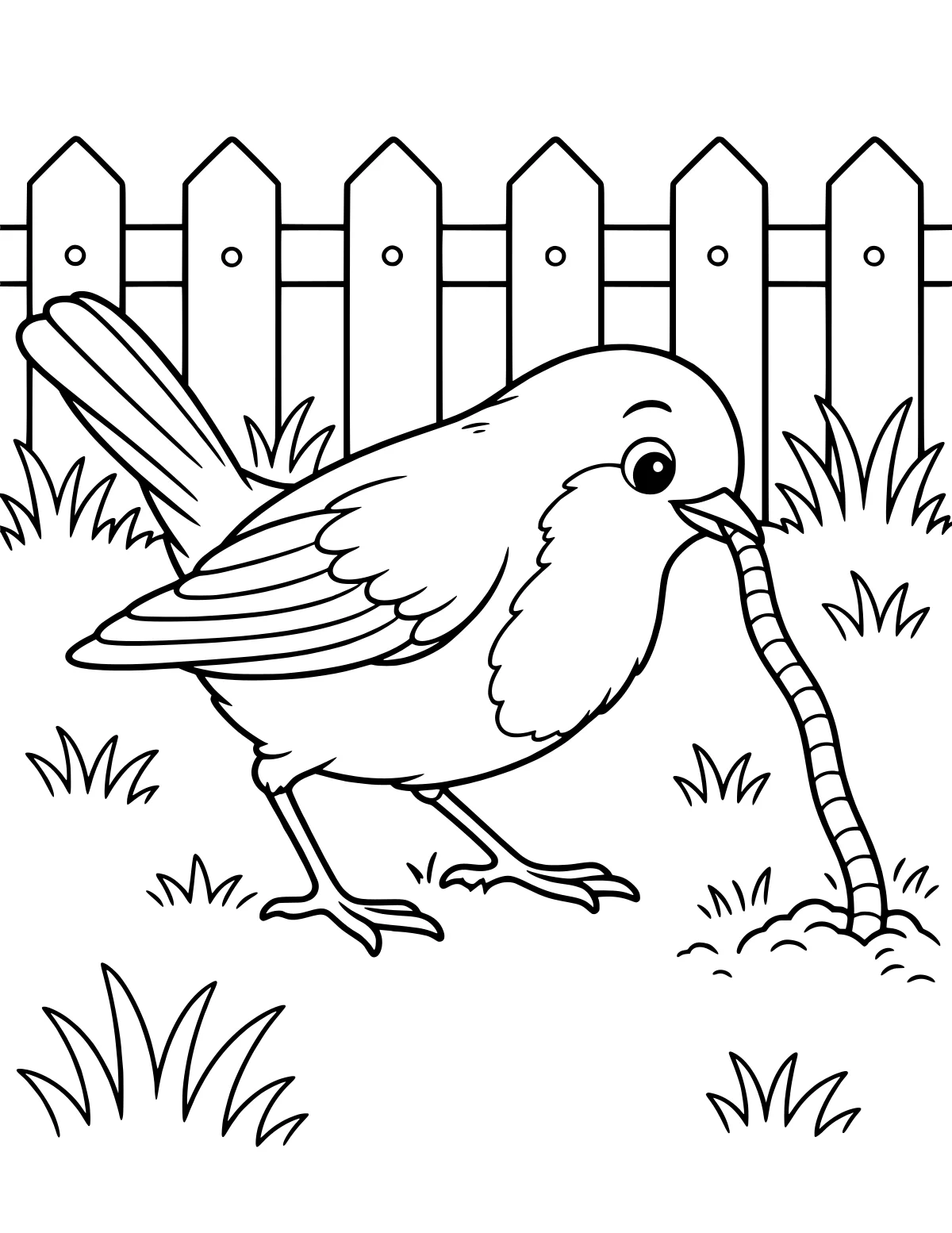 Bird gripping a long worm in its beak beside grass and a pointed picket fence.
