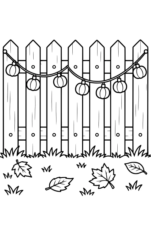 Pumpkin-shaped lights hanging in curved strands across a pointed wooden fence, with grass and fallen autumn leaves below.
